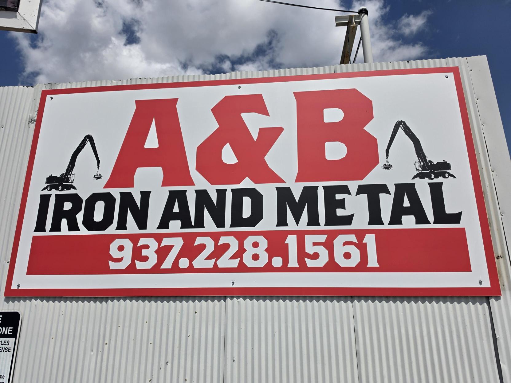 A&B Iron and Metal sign with the yard phone number on the Washington Street fence